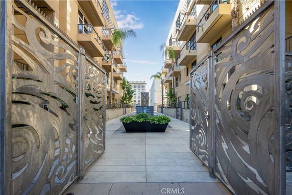 Front view of a modern multi-story building with decorative gates and balconies.