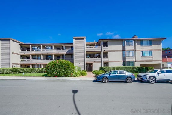 Front view of a multi-story residential building with balconies.