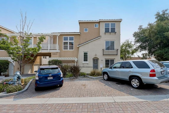 Front view of a multi-story house with attached garages.