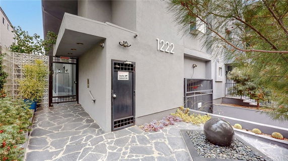 Front view of a building with a modern entrance and decorative landscaping.