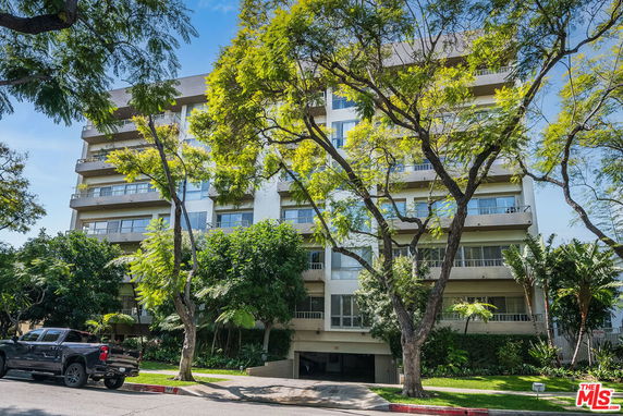 Front view of a multi-story residential building with balconies.