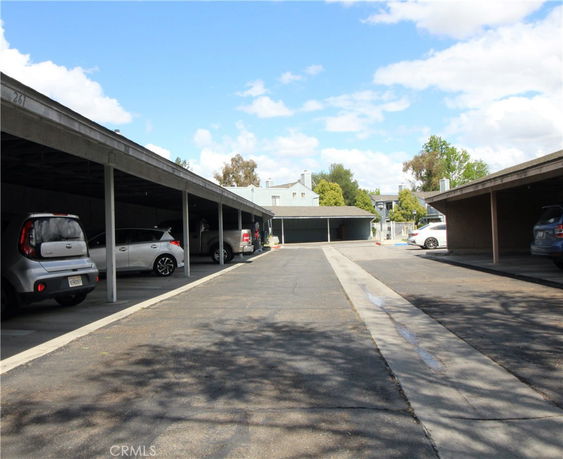 Outdoor parking area with covered parking spaces.