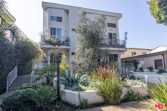 Front view of a modern two-story house with balconies.