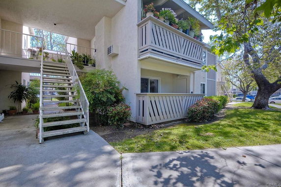 Front view of a two-story building with balconies and external stairs.