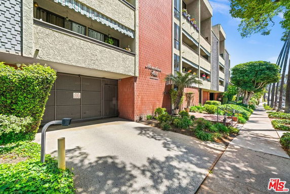 Front view of a multi-story residential building with balconies.