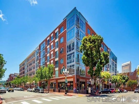 Front view of a multi-story building with commercial spaces on the ground floor.