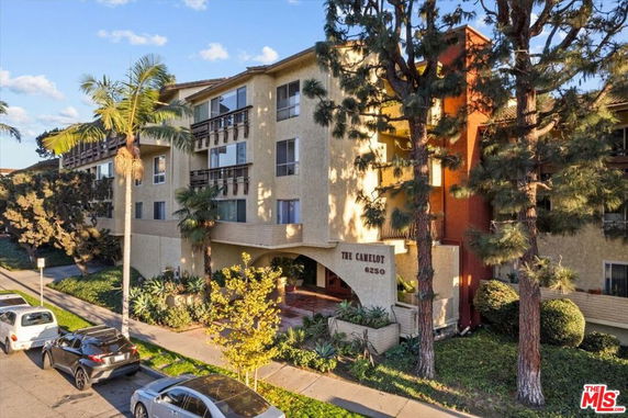 Front view of a multi-story residential building with balconies.