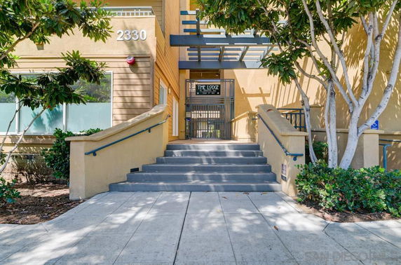 Front view of a building entrance with stairs leading up.
