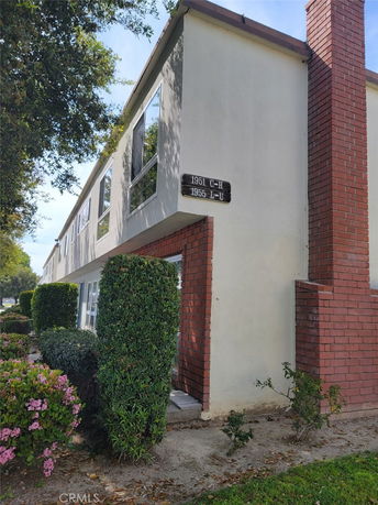 Front view of a two-story building with a brick chimney.