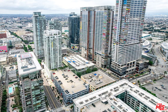 Panoramic view of a cityscape with tall buildings and surrounding streets.
