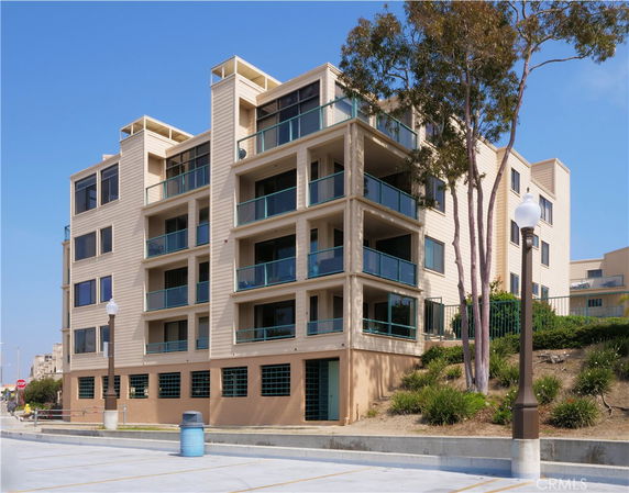 Front view of a multi-story apartment building with balconies.