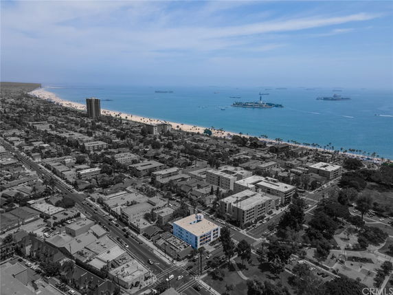 Panoramic view of a coastal city with apartment buildings and beach.