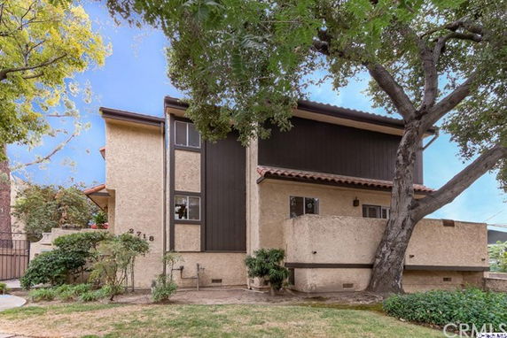 Front view of a two-story house with a modern design and a beige exterior.