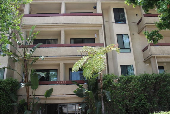 Front view of a multi-story residential building with balconies.