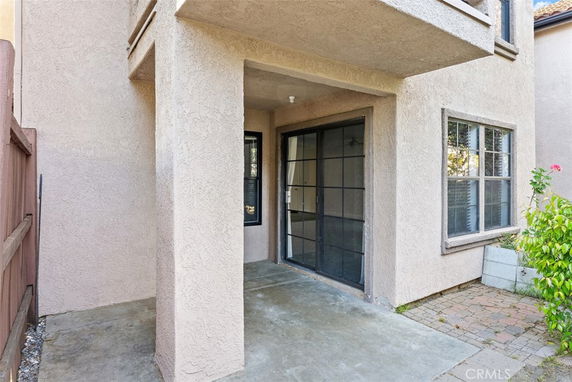 Exterior view of a house with sliding glass doors and windows.
