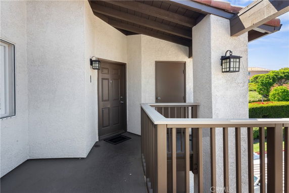 Front view of a house entrance with a small porch and railing.