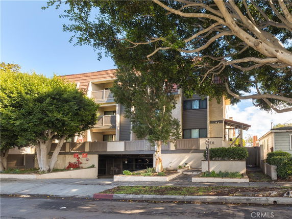 Front view of a multi-story residential building with balconies.