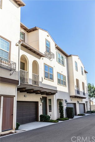 Front view of a multi-story residential building with garages.