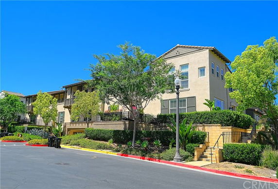 Front view of a multi-story residential building with balconies.