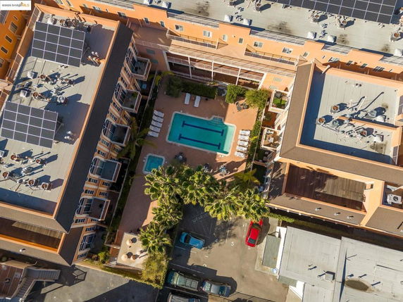 Aerial view of a building with solar panels on the rooftop.