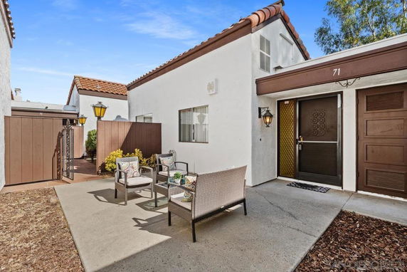 Front view of a single-story house with a patio area.