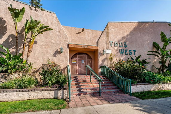 Front view of a building with the name 'Taos West' on the exterior.