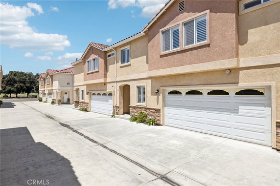 Front view of a two-story residential building with a double garage.