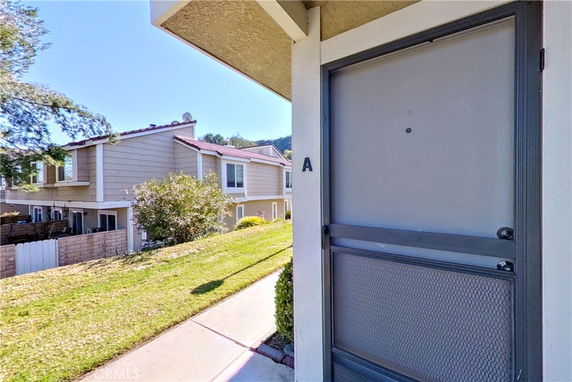 Front view of a building with a screen door and unit marked 'A'.