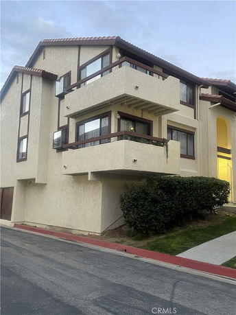 Front view of a multi-story building with balconies.