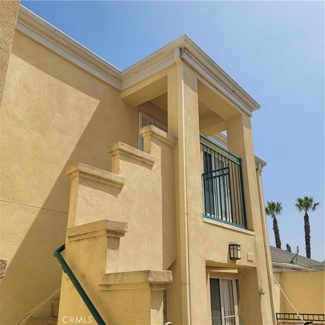 Exterior view of a two-story building with a staircase.