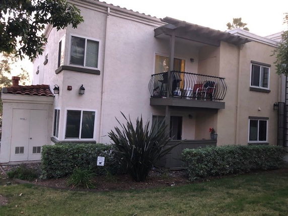 Front view of a two-story residential building with a balcony.