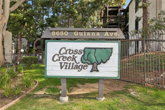 Signboard of Cross Creek Village at 8650 Gulana Ave showing entrance to the residential complex.