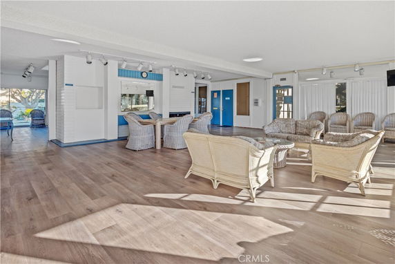 Interior view of a club house with wicker furniture and wooden flooring.