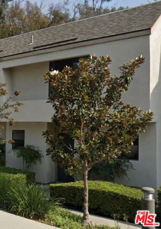 Front view of a two-story building with a sloped roof.