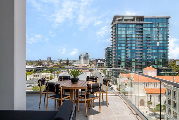 Balcony view overlooking a cityscape with modern high-rise buildings.
