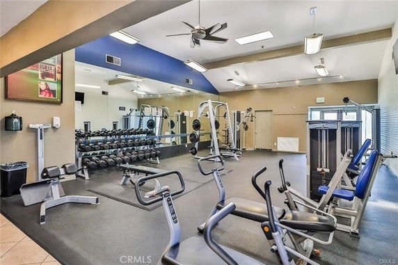 Interior view of a fitness area with exercise equipment and weights.