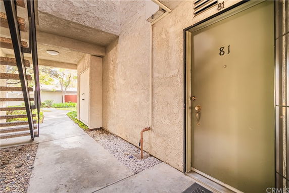 Front view of a building entrance with door number 81.