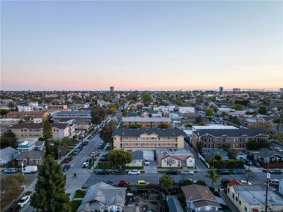 Wide aerial view of a residential area with multiple buildings and streets.