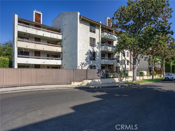 Front view of a multi-story residential building with balconies.