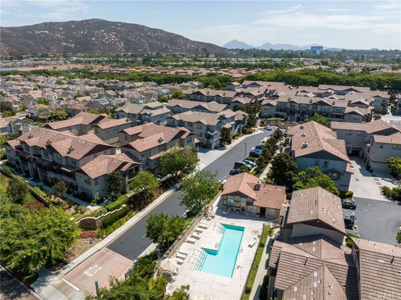 Aerial view of a residential area with multiple houses and a swimming pool.