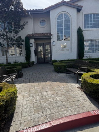 Front view of a building with large windows and a central entrance marked as a clubhouse.