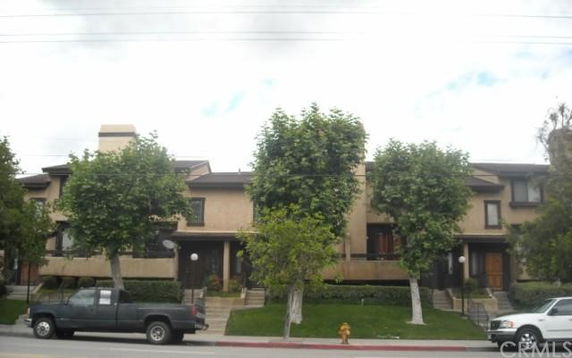 Front view of a two-story residential building with multiple entryways.