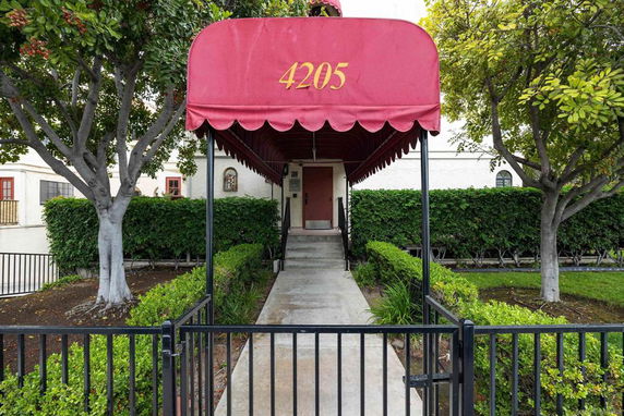 Front view of a building entrance with a red canopy.