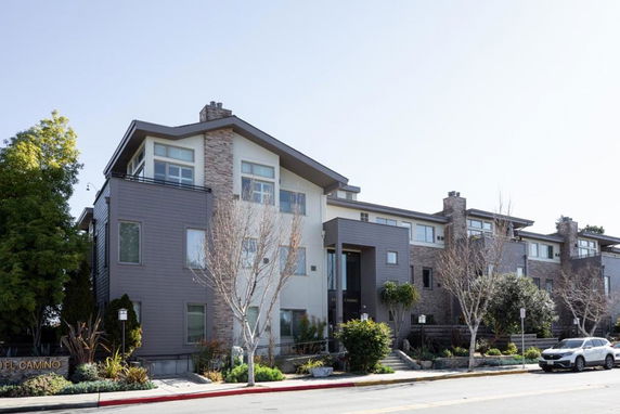 Front view of a multi-story residential building with a modern exterior design.