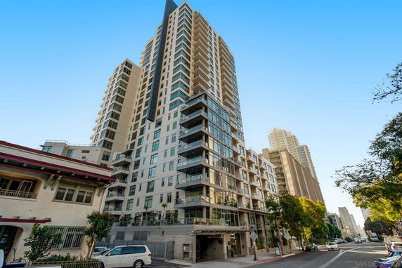 Front view of a high-rise residential building with multiple balconies.