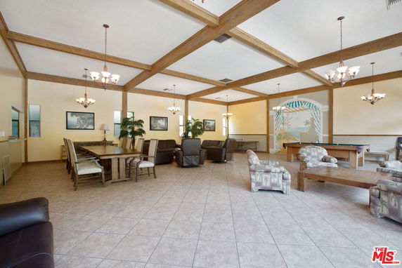 Spacious indoor recreational area with seating and tables.