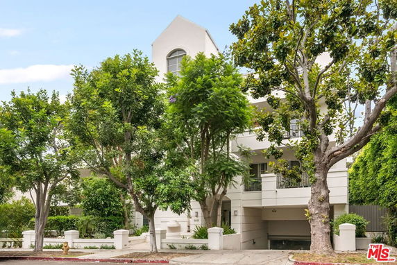 Front view of a multi-story residential building with balconies.
