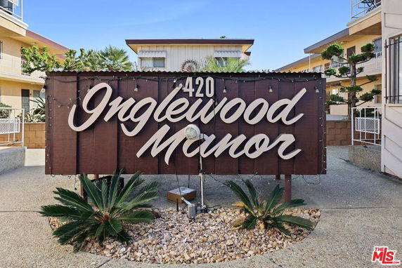 Front view of a building with a sign reading 'Inglewood Manor'.