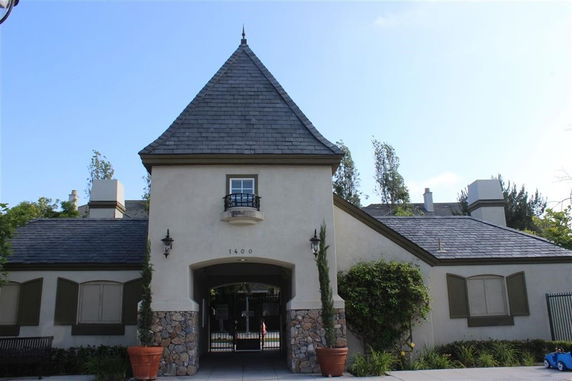 Front view of a house with a steeply pitched roof and stone accents.