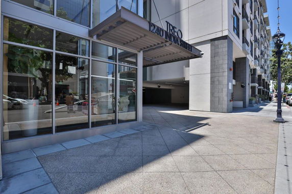 Front view of a building with large glass windows and an entrance canopy.